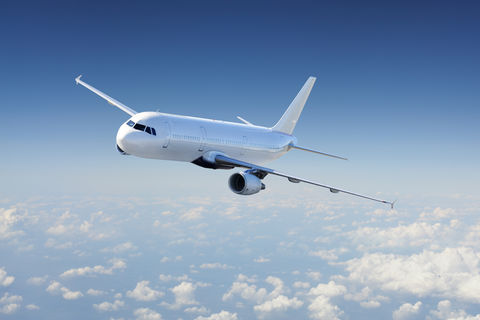 Big Passenger airplane flying over cloudy sky